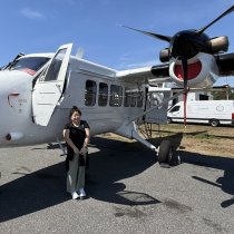 Dr. Di Yang standing by airplane