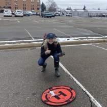 Kit Lewers stands behind her drone landing pad