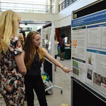 Intern presenting poster at event