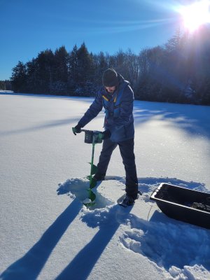 Field ecologist Aaron Schoofs checks the ice depth at Crampton Lake (CRAM). Photo credit: Jill Pyatt