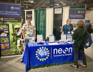 Ryan McClure behind the NEON exhibit booth at ESA 2024