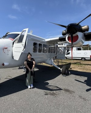 Dr. Di Yang standing by airplane