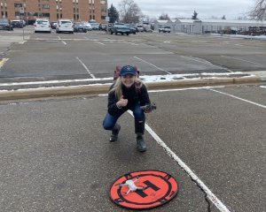 Kit Lewers stands behind her drone landing pad