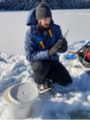 NEON field ecologist samples surface water for microbes during winter at D05 CRAM (Photo by Hannah Beeler)