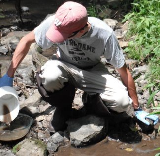 Sampling stream sediments using the hand scoop