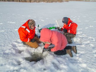 Field technicians sampling in the snow