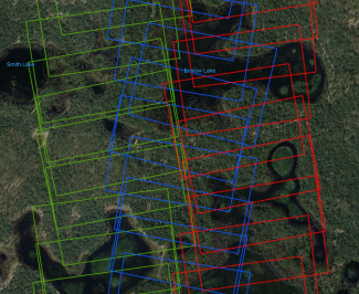 Figure 1 - Sample of the flight track for camera data collected on April 15th, 2019 over the site DSNY showing the extent of overlap among the images. Green, red and blue images were captured in three respective flight lines. (Background from GoogleEarth) 