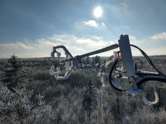 Rime ice covers the Steigerwaldt (STEI) tower and surrounding treetops on a crisp midwinter day.