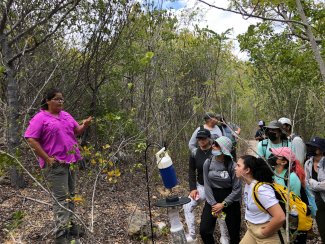 Arlene Megill showing students how NEON staff set mosquito traps and the purpose of collecting the data.