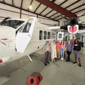Plane in a hangar with people
