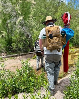 Ecologists walk to a river