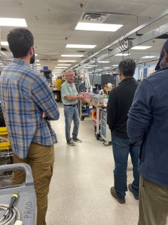 Doug Kath showing the calibration lab to a tour group