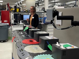 Janae Csavina explains instrument calibration to a tour