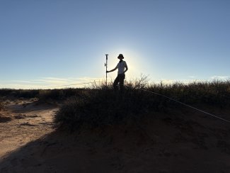 Alexi Besser collecting data at JORN NEON field site