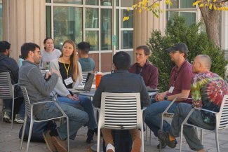 Alexi Besser in a discussion with other participants at the 2025 NEON Convergence Summt