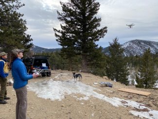 Anna Spiers piloting an unmanned aerial vehicle in the mountains