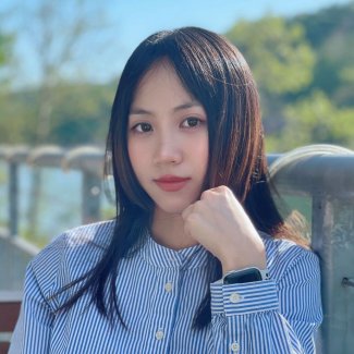 ProfessionalHeadshot of Yiting Fan outside with trees and a railing behind her.