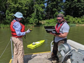 Field technicians doing arcboat tests for bathymetry mapping at the BLWA aquatic site
