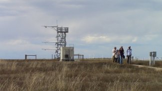 People walking away from a flux tower
