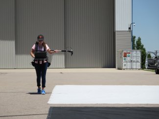 Maddy Ball measures tarp reflectance for use in airborne spectrometer calibration.